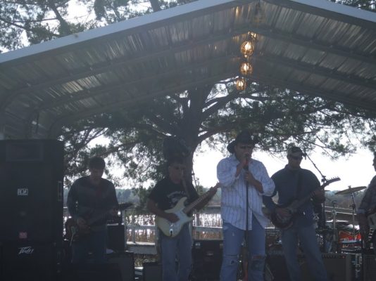 Musician playing on outdoor stage.